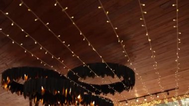 Restoranın terasında ampulleri olan büyük, güzel bir tasarımcı modern avize.