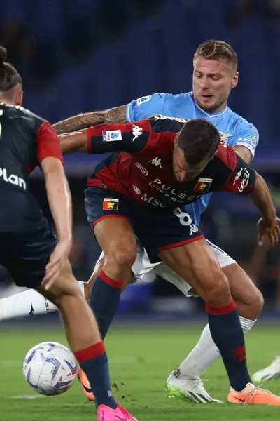 stock image Rome, Italy 27.08.2023: Kevin Strootman of Genoa, Ciro Immobile of Lazio in action during the Italy Serie A TIM 2023-2024 football match day 2, between SS Lazio vs Genoa CFC at Olympic Stadium in Rome.