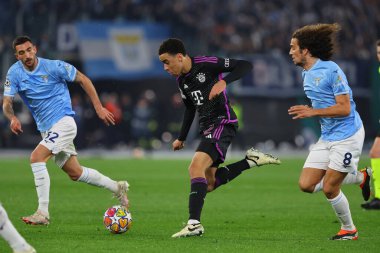 Roma, İtalya 14.2.2024: Bayern Munchen 'den Jamal Musiala, 2023-2024 Uefa Şampiyonlar Ligi karşılaşmasında Lazio' lu Guendouzi, 16 futbol karşılaşmasında SS Lazio ile FC Bayern Mucnhen Roma Olimpiyat Stadyumu 'nda karşı karşıya geldi..