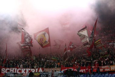 Roma, İtalya 14.2.2024: Bayern taraftarlarından dumanlı bombalar ve bayraklar Uefa Şampiyonlar Ligi 2023-2024 karşılaşmasında, 16 futbol karşılaşması SS Lazio 'ya karşı FC Bayern Mucnhen Roma Olimpiyat Stadyumu' nda.