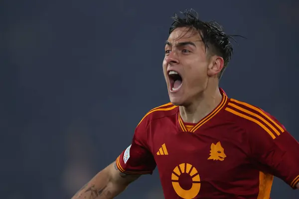 stock image Rome, Italy 18.04.2024:  Paulo Dybala of Roma score the goal 2-0 and celebrate with the team during the UEFA Europa League 2023-2024, quarter final , football match between AS Roma vs AC Milan at Olympic Stadium in Rome.