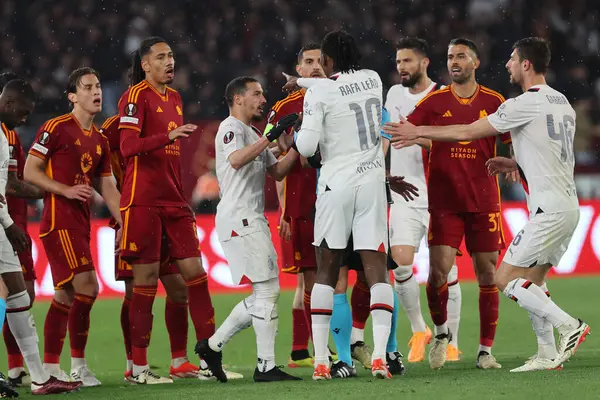 stock image Rome, Italy 18.04.2024:  Rafael Leao of Milan Protest against Leandro Paredes of Roma for kick from behind during the UEFA Europa League 2023-2024, quarter final , football match between AS Roma vs AC Milan at Olympic Stadium in Rome.