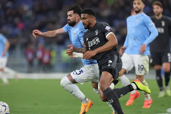 Stock image Rome, Italy 23.04.2024: Elseid Hysaj, Gleison Bremeer of Juventus during Italy Cup - Coppa Italia Frecciarossa 2023-2024 semi-finals football match derby SS LAZIO  vs JUVENTUS FC 1909 at Olympic Stadium in Rome.