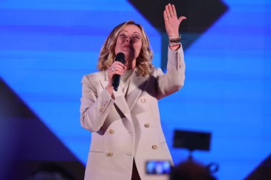 Rome, Italy 14.12.2024:  Italian Prime Minister Giorgia Meloni blows a kiss with her hands during the political event organized by the governing party Fratelli D'Italia called Atreju 2024 at the Circo Massimo in Rome clipart