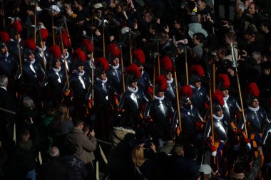 Vatican City, Italy 25.12.2024 : The Swiss Guard in full uniform marching into the square to take up position under the central loggia of St. Peter's Square, on the occasion of Pope Francis' Urbi et Orbi blessing for Christmas. clipart