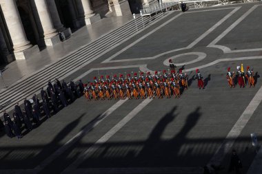 Vatican City, Italy 25.12.2024 : The Swiss Guard in full uniform marching into the square to take up position under the central loggia of St. Peter's Square, on the occasion of Pope Francis' Urbi et Orbi blessing for Christmas. clipart