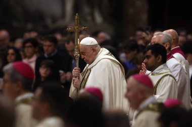 Rome, Italy 06.01.2025 : Pope Francis Bergoglio holds the cross during s the celebration of the Epiphany of the Lord Holy Mass on Altar of the Confession, St. Peters Basilica clipart