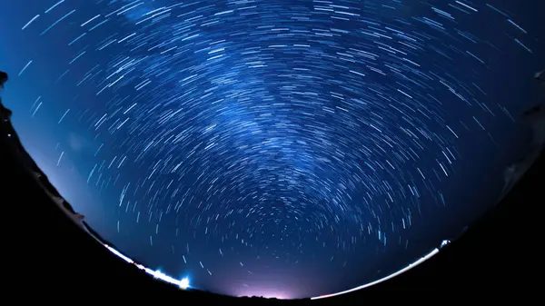 Universe Star Trails of Polaris North Star Fisheye Panorama in Blue Sky Astrophotography