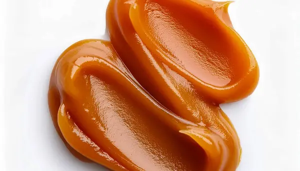 stock image  Smear of tasty caramel paste on white background, top view