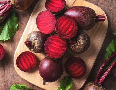 Red beetroot and beetroot cross sectoin in wooden cutting board isolated on wooden background. tropical concept background. clipart