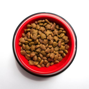 Dry cat food in a red bowl, isolated on a clean white background