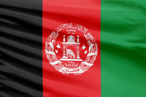 stock image Afghanistan flag is depicted on a sport stitch cloth fabric with folds.