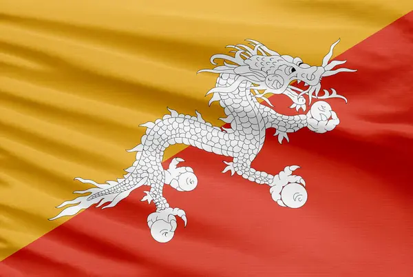 不丹国旗被描绘在有褶皱的运动针织物上 — 图库照片