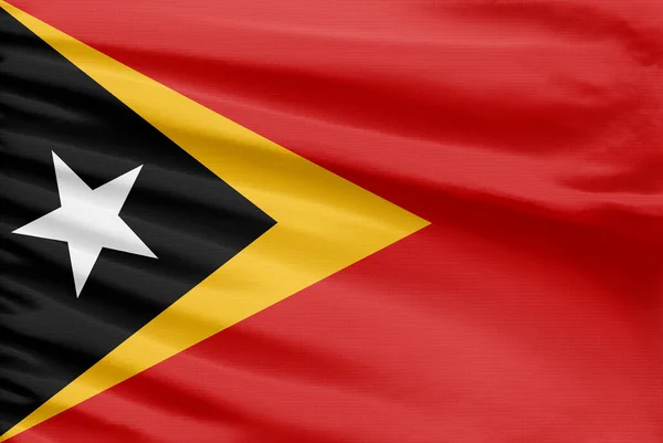 Bandeira Timor Leste Representado Tecido Pano Costura Esporte Com Dobras — Fotografia de Stock