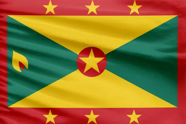 グレナダの旗は折り目が付いているスポーツのステッチの布の生地に描かれています — ストック写真