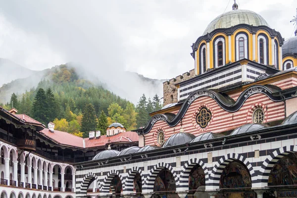 stock image Courtyard of the Rila Monastery in front of foggy mountains in Bulgaria