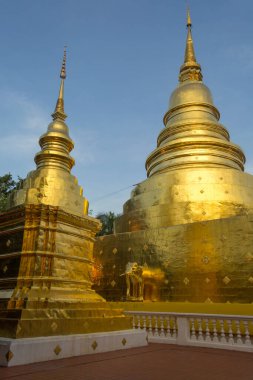 Phrathatluang, Golden figurines of elephants at temple Wat Phra Singh. Thailand.