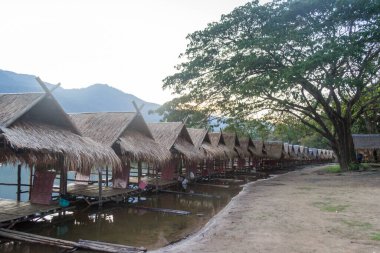 Straw floating huts on the water at Huay Tueng Thao Reservoir in Chiang Mai, Thailand.