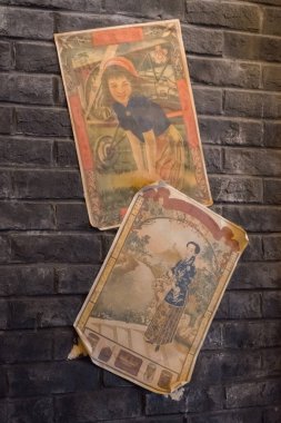 Shanghai, China - Oct 16, 2023: Historic old Shanghai street with vintage Shanghainese girls posters.