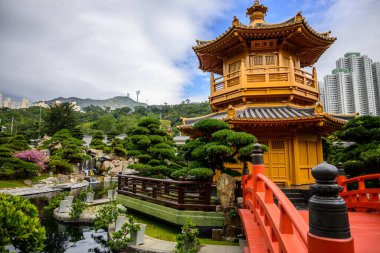 Karmaşık bir şekilde oyulmuş demiryolu ile kırmızı ahşap bir köprü altın pagoda, Mutlak Mükemmellik Pavyonu 'na götürür, Nan Lian Garden, Hong Kong' da siyah kiremitli bir çatı