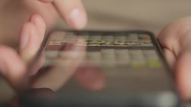 A mans finger touches a monitor to scroll a page on a mobile phone. Viewing photos and documents in the smartphone library. A man in his hands uses a smartphone, turns pages.