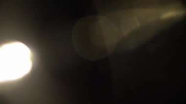 Light permeates the frames on a black baLight permeates the frames on a black background. Studio lens flare. Natural lighting lamp rays Bokeh effect. For composing footage, video styling, transitions