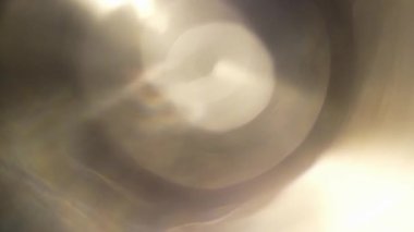 Light permeates the frames on a black baLight permeates the frames on a black background. Studio lens flare. Natural lighting lamp rays Bokeh effect. For composing footage, video styling, transitions