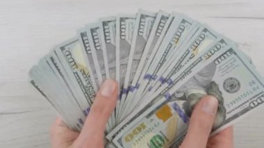 Smartphone green blue screen, man counting dollars cash. Paper money and mobile phone chroma key. Hands hold American dollars, put on table. Banking, work and earnings Internet online and business