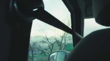 Rain on the windshield of the car, rain brushes are working. Going to nature in the spring. Rainy season, raindrops wash the glass. Concept of weather forecast, hydromecenter, background