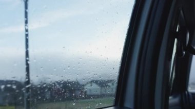 Rain on the windshield of the car, rain brushes are working. Going to nature in the spring. Rainy season, raindrops wash the glass. Concept of weather forecast, hydromecenter, background