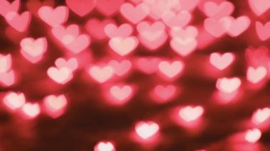 Many red hearts. ConcepMany red hearts. Concept: valentines day, anniversary, mothers day, marriage, e-card invitation. Defocused light lights, colorful hearts animation. The movement of the camera