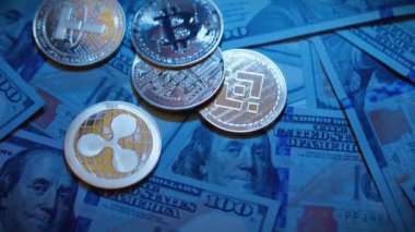 Cryptocurrency Bitcoin, Ethereum, Tether, Binance USD, XRP, Dogecoin and US dollar banknotes on blue background. Crypto exchange trading. Blockchain digital financial transactions. Investment business