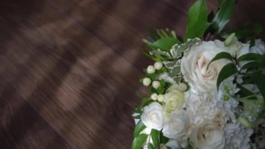 Wedding bouquet close-up. Decoration of roses and ornamental plants close-up. Traditional wedding decoration and holiday element. Flowers and decoration to order. Selective focus.