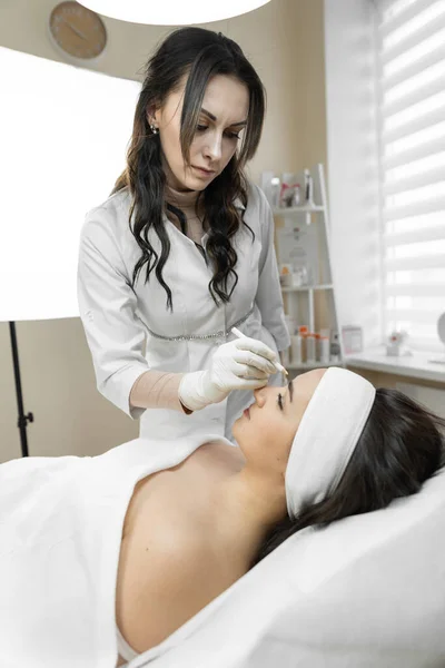 Instant transformation, where the botulinum therapy procedure gives the woman a flawless face and removes skin imperfections with injections. Procedure in the beauty salon for rejuvenation. High