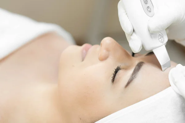 Softness and smoothness: as ultrasonic facial cleansing gently and effectively cleanses the skin, improving its texture. Beautician in the beauty salon performs a hardware procedure for cleansing the