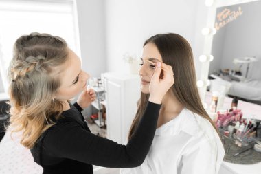 Kaş tasarımcısının kaşların şeklini düzeltmek için çalıştığı anı aktarır. Her detay önemlidir ve güzellik uzmanının her hareketi kadınlara çekici bir yüz verir.