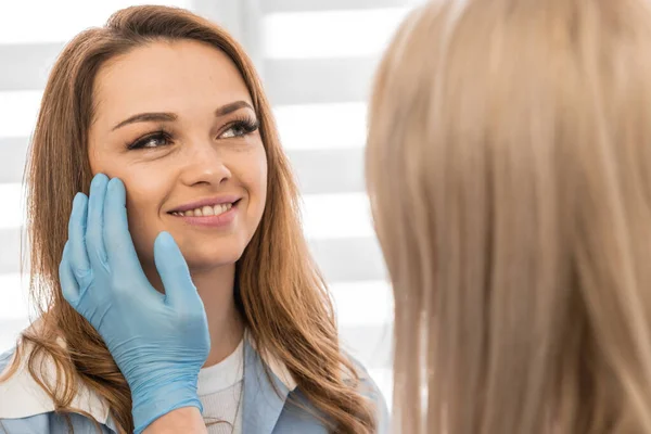 The path to healthy skin: The patient turns to a cosmetologist for consultation and receives an individual approach to improving the condition of the skin of the face. High quality photo