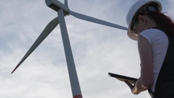 Female Engineer Glasses Helmet Stands Next Huge Wind Turbine Monitoring — Stock Video