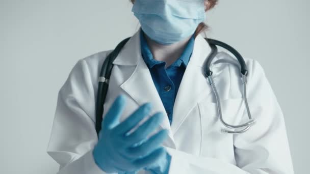 戴着防护手套和听诊器的医务人员的肖像是健康和信任的象征 医生给小龙虾戴上防护医用手套 并把手套直了直 医疗诊所 — 图库视频影像
