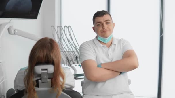 A dental clinic and a professional dentist in the treatment room with the patient provides various medical services for teeth whitening, taste correction, as well as implant installation and modern