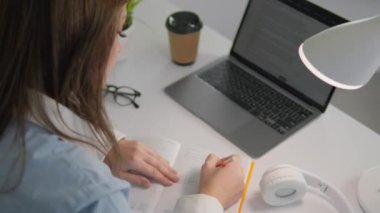 Bayan öğrenci bu materyali yoğun bir şekilde inceleyerek, eğitim ve hazırlık için teknolojiyi kullanıyor. Konsantrasyonu ve internet kaynaklarıyla etkileşimi bilgi ve becerilerin geliştirilmesine yardımcı oluyor. Yüksek