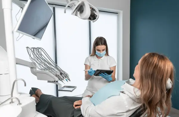 The dentist determines the timing and sequence of treatment procedures. The patient receives an individualized treatment plan to maintain the health of their oral cavity. The patient is in a calm and