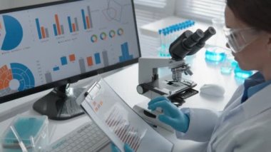 Bilgisayar araştırma merkezindeki laboratuvar çalışmaları kimyasal süreçler ve yeni tıbbi teknolojilerin geliştirilmesine adanmıştır. Tehlikeli madde giysisi içinde, bilim adamı dikkatle inceler.