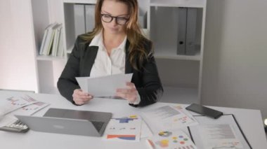 A professional specialist makes a successful career movement, working on important financial projects. The head of the office keeps records and analyzes the effectiveness of business processes in her