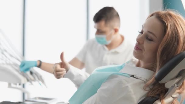 Beautiful Woman Sits Comfortably Dental Chair Approving Hand Gesture Recommends — Stock Video
