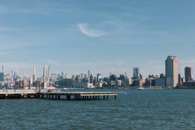 picturesque view of New York bay with pier and skyscrapers of Manhattan clipart