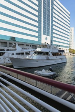 contemporary building and pier near private yachts in New York City