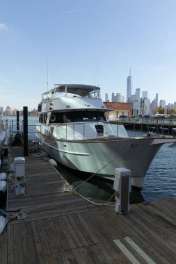 white modern yacht near pier on Hudson river in New York City