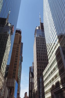 low angle view of modern skyscrapers against blue sky in financial district of New York City