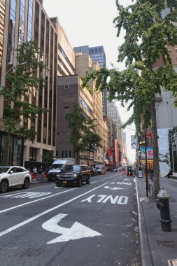 NEW YORK, USA - OCTOBER 13, 2022: urban street with cars and pedestrians in Manhattan district
